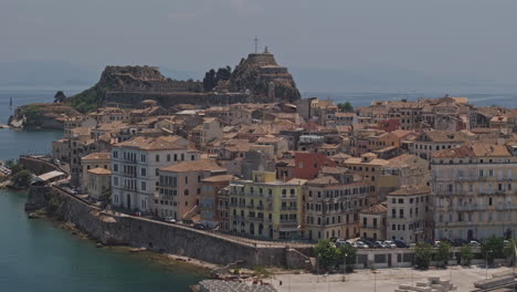 corfu greece aerial v29 flyover port harbor capturing waterfront townscape lined with venetian-style buildings and old fortress dominating the background - shot with mavic 3 pro cine - july 17th 2024