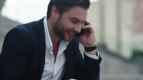 Businessman-talking-on-mobile-phone-at-street.Worker-celebrating-victory-outside