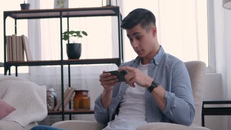 young man using smartphone at home