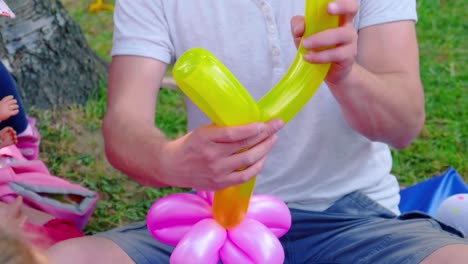 colorful celebration of a man making balloons for the children's birthday