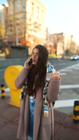 young woman talking on phone in city