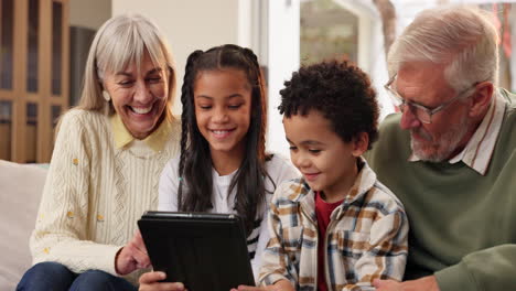grandparents and grandchildren enjoying tablet time together
