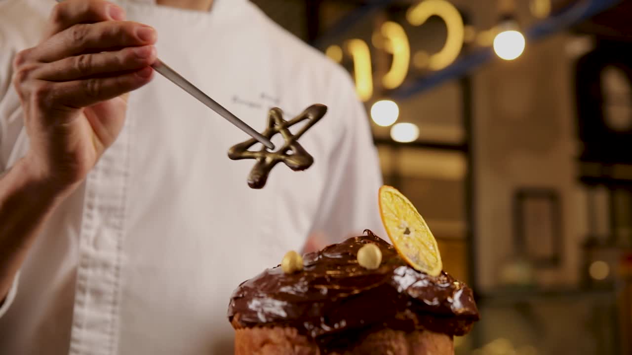 셰프가 파네토네를 장식하고 있습니다.