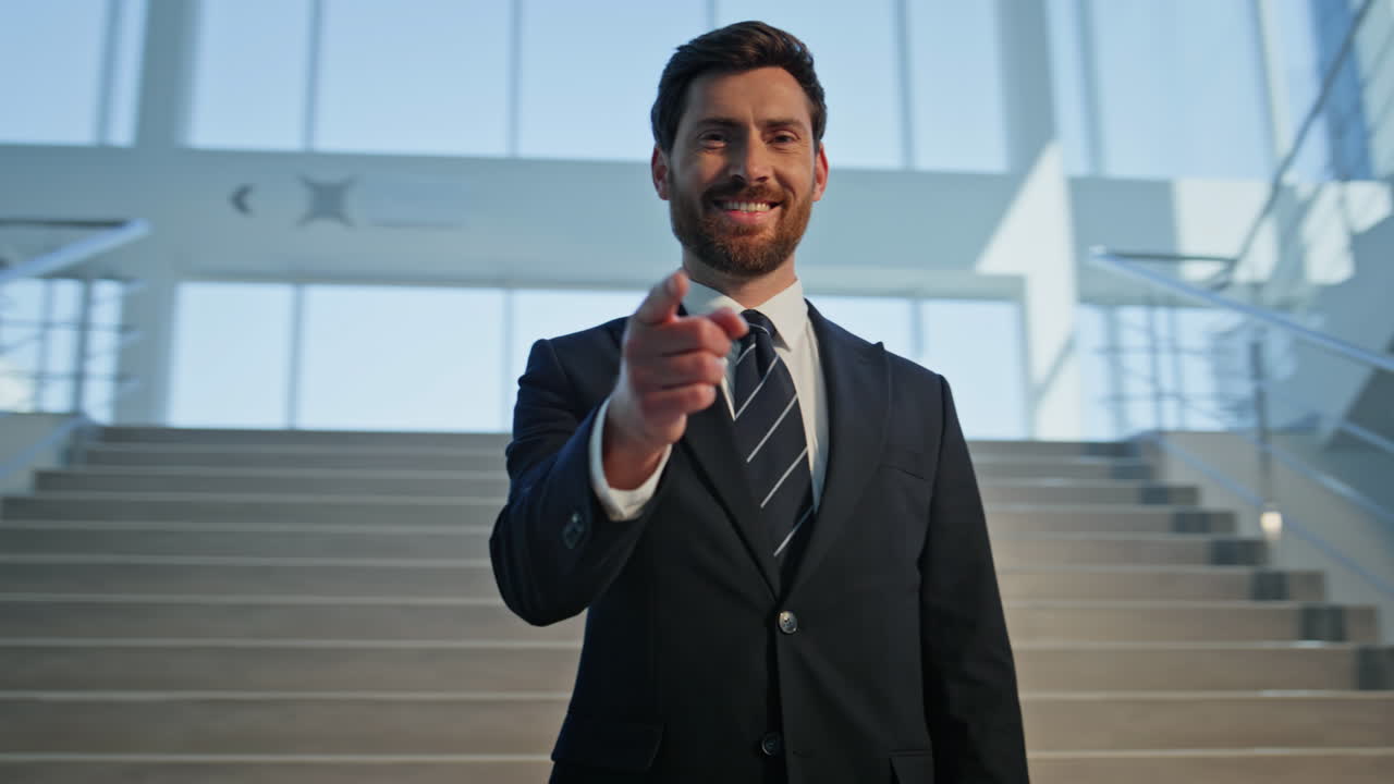 Confident leader pointing camera standing on stairs corporate building closeup