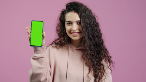 woman holding green screen smartphone