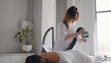 lpg massage for health and beauty masseur is massaging hips and buttock of adult female client