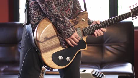 male rock star musician playing guitar