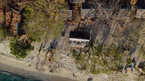 Top-down-drone-footage-of-bamboo-houses-on-the-beach-near-Palawan-in-the-Philippines