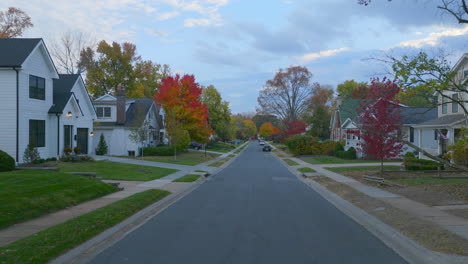 pull back down a surburban street in autumn