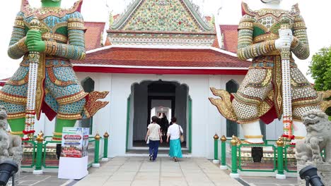 people entering wat arun, bangkok, thailand