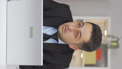 vertical video of home office worker man has eye pain.