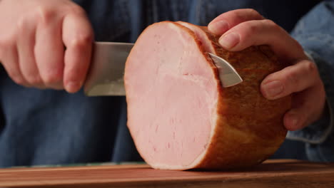 slicing a round of ham
