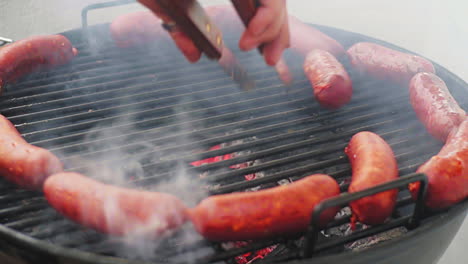 panning shot of rolling mexican grill sausage surrounded by ring of sausage on bbq