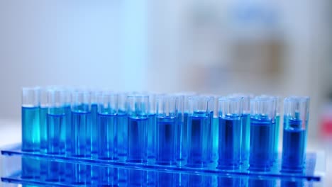 pipette dripping chemical substance in glass tube close-up, lab experiment