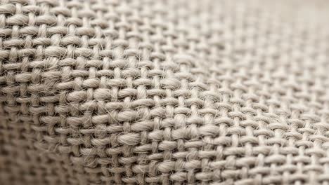 close-up observations of textured fabric showing intricate weave patterns and natural fibers, highlighting its unique characteristics and craftsmanship