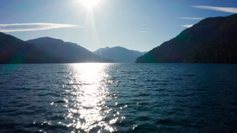 Low-aerial-over-wavy-water-toward-Andes-mountains-in-evening-sunlight