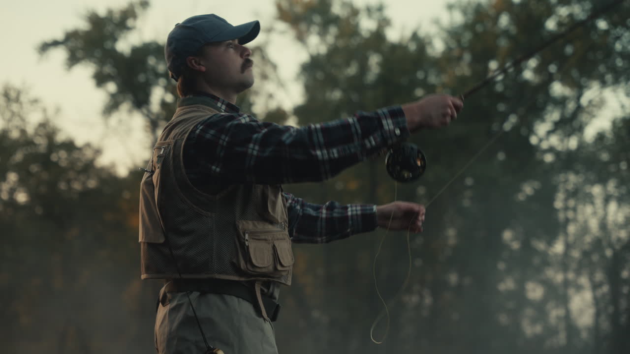 Man Fly Fishing in the Woods at Sunrise