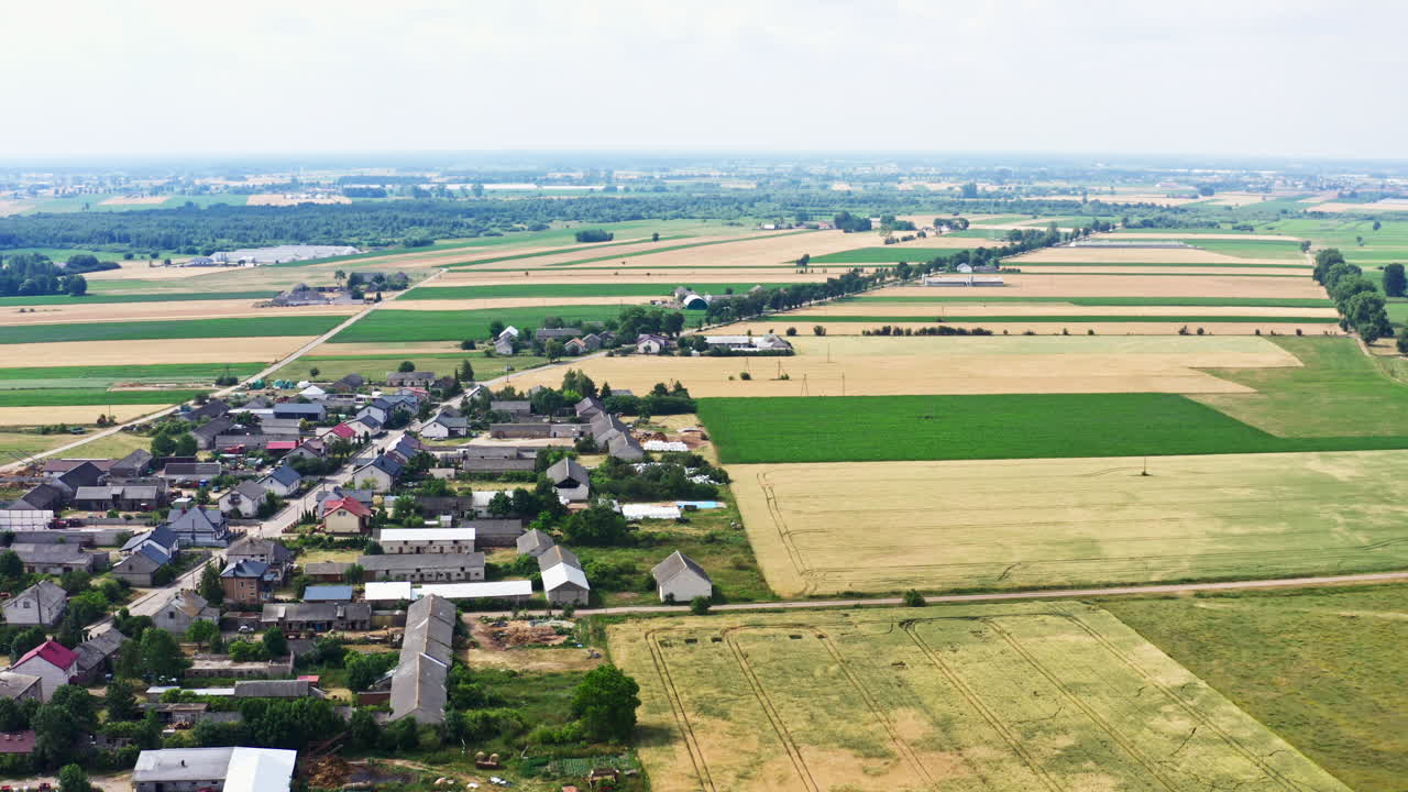 Residential Houses In The Village Surrounded With Countryside Fields. - aerial shot