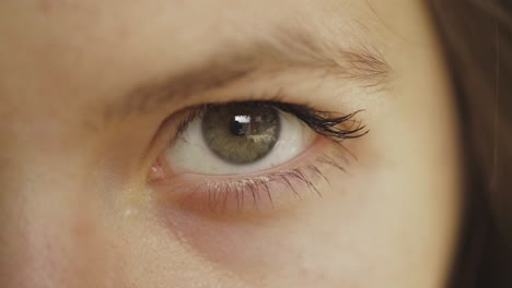 girl's left eye closes tightly for few seconds and open again - close up