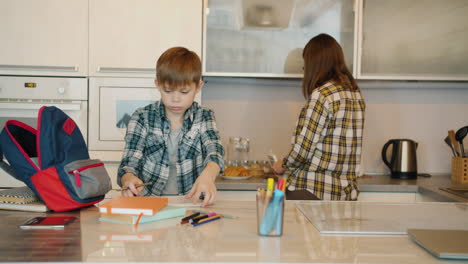 mom and son studying in the kitchen