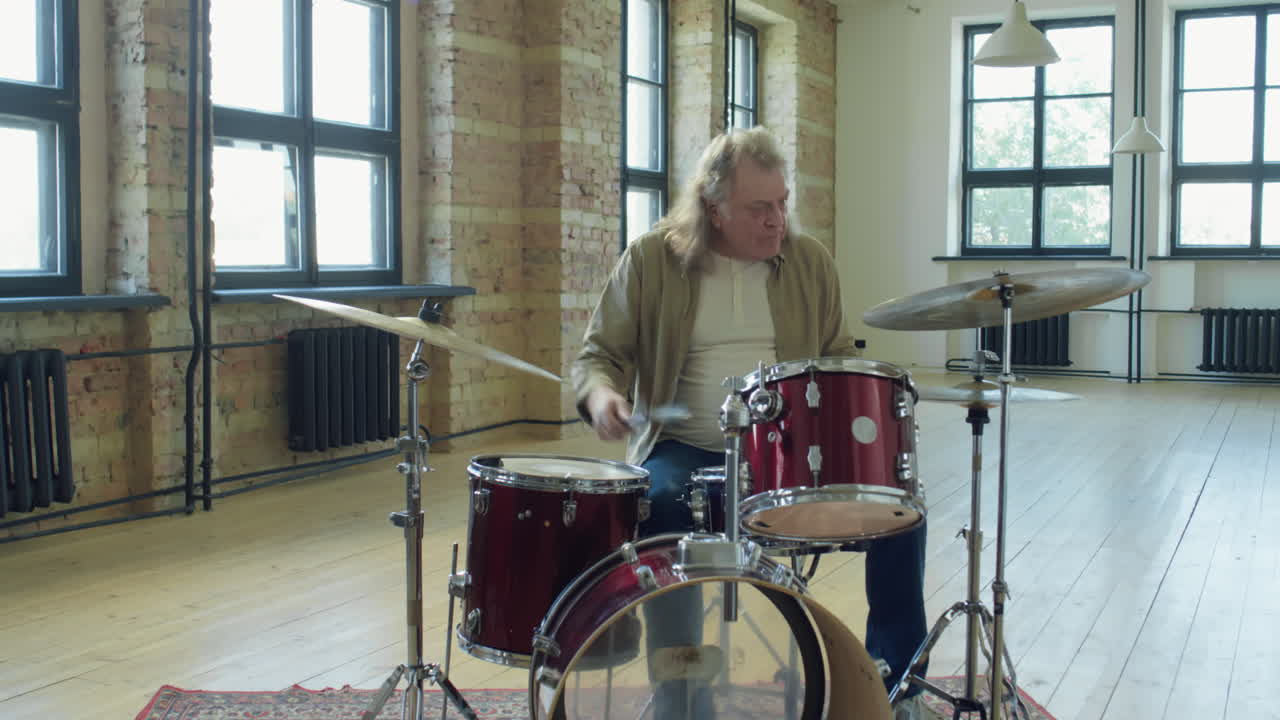 Senior Drummer Playing Music in Studio