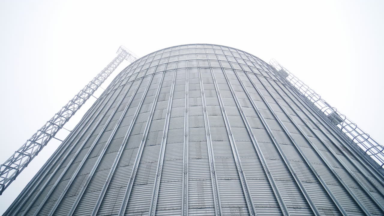 Huge steel elevator storage. Food industry agricultural tank.