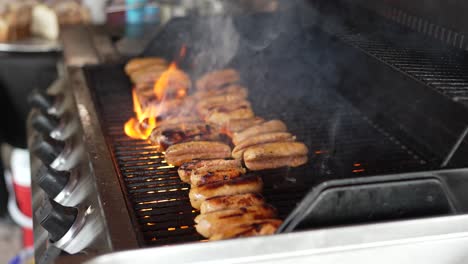 Chorizos-Cooking-and-Moved-with-Tongs-on-BBQ-Grill