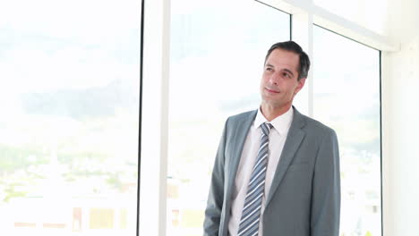 thoughtful businessman looking away in office