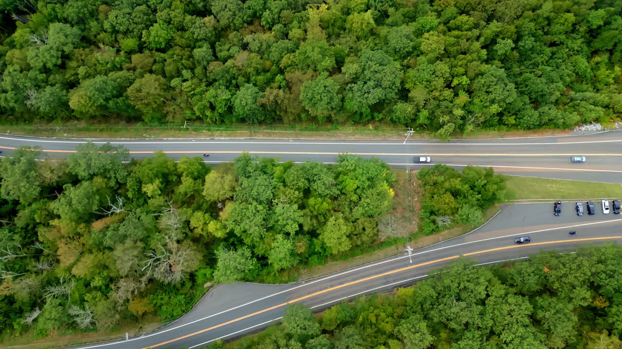 Top-down aerial movement over the Mohawk Trail scenic road while cars driving along the serpentine mountain road, Berkshire, Massachusetts, USA