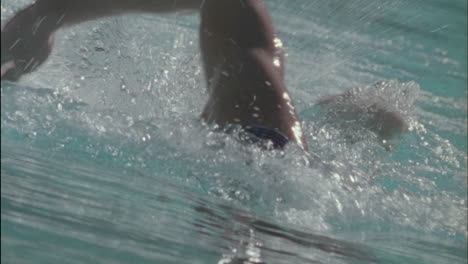 a man swims to the other side of a pool