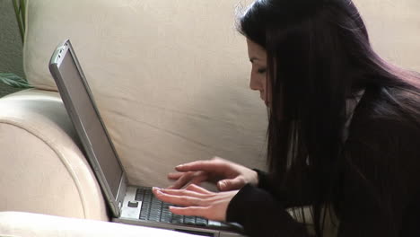 woman on sofa with laptop