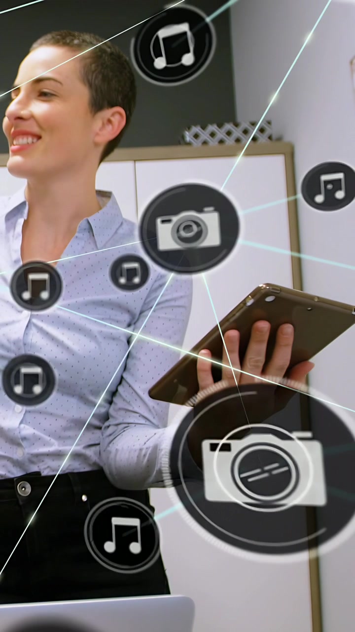 Vertical video: Woman holding tablet, UI appearing, media icons spreading and moving overlay for IT