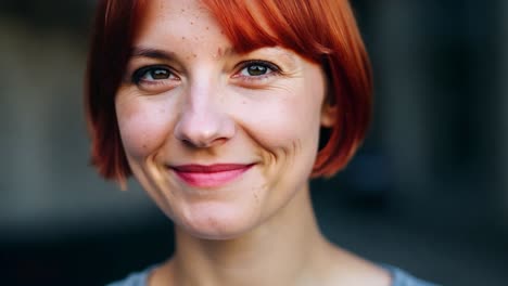 portrait of a smiling woman with red hair