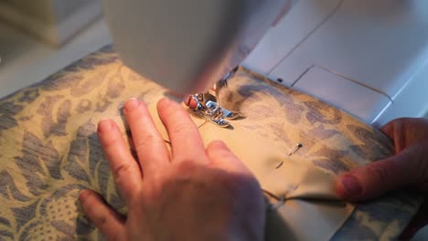 close up of woman sewing curtains in slow motion