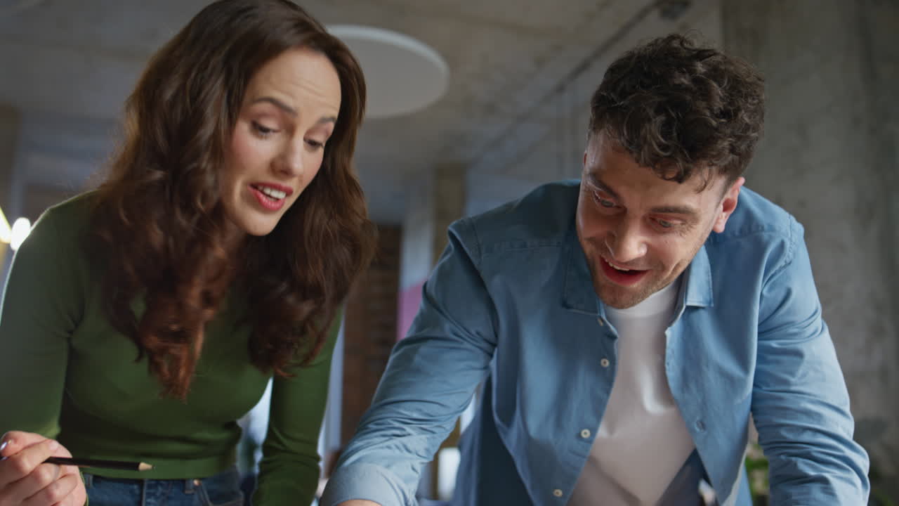 Skilful colleagues creating blueprint at open space closeup. Coworkers drawing