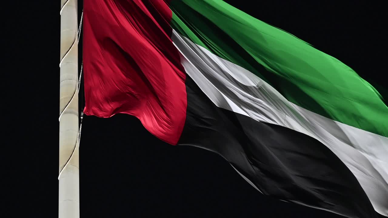 Closeup: Night view of the Flag of UAE, The national symbol of the United Arab Emirates