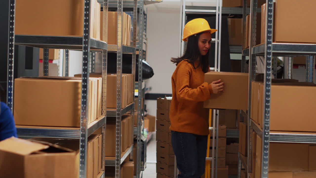 Warehouse workers with boxes and laptop