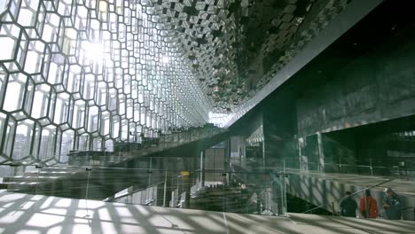 inside the modern reykjavik opera house with geometric glass walls and grand staircases