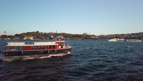 evening, cinematic slow-mo, picturesque view of sarayburnu from ferry on golden horn in istanbul