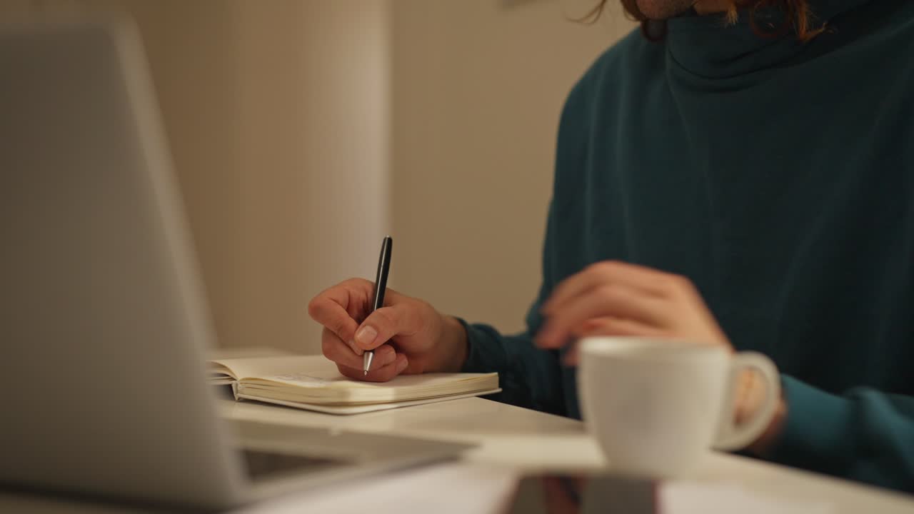 Working at a desk with a laptop and notebook