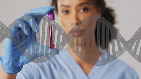 animation of dna strand and biracial female doctor with vial on white background