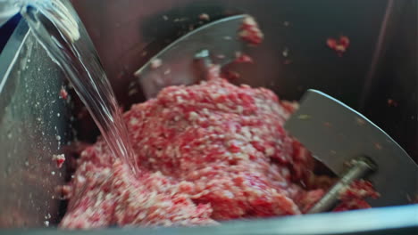 minced meat being processed in a meat grinder