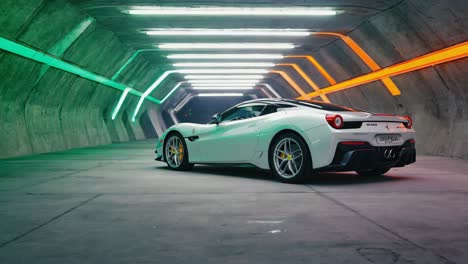 white sports car in a neon-lit tunnel