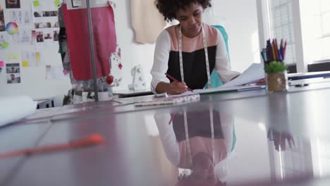 Mixed-race-woman-working-in-fashion-office
