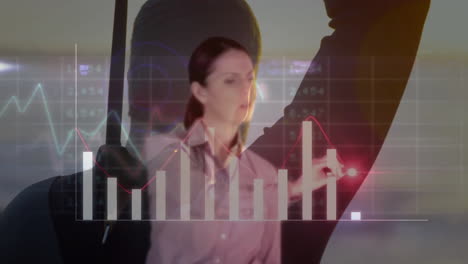 analyzing financial graphs, businesswoman using animation with digital data in office
