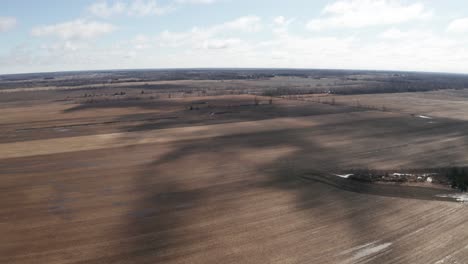 Shadows-of-clouds-over-wide-open-fallow-farm-fields-in-early-Spring-before-planting