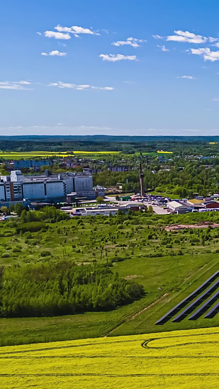 Cityscape view with green fields, clear blue sky in a vertical timelapse