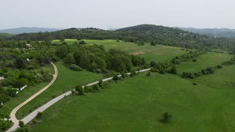 Drone-following-a-moving-vehicle-through-the-plains-of-a-place-known-as-Tsarichina-Hole-or-Area-51,-located-near-the-Strandzha-Nature-Park,-in-Bulgaria