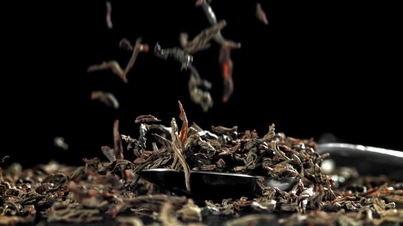 Slow Motion of Dried Tea Leaves Falling onto a Spoon