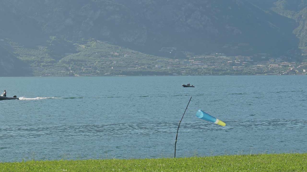 Windsock in paraglider landing zone shows lake shore breeze direction